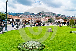 People at the Main Square Plaza de Armas with the Statue of Pachacuti and cityscape of Cusco in Peru