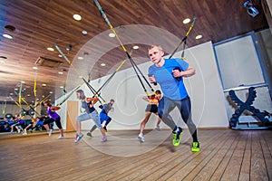 People make fitnes exercise with a band in the gym