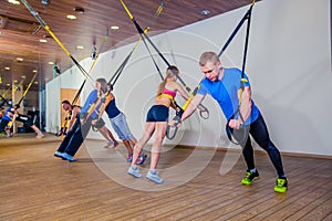 People make fitnes exercise with a band in the gym