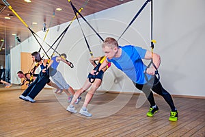 People make fitnes exercise with a band in the gym