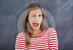 People make funny faces before they sneeze. a young woman sticking her tongue out.