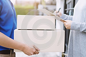 People man signing receipt receiving package parcel delivery man of a package