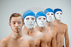 The people in masks and one man without mask