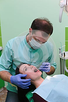 People, medicine, stomatology and health care concept - close up of dentists and assistant with mirror