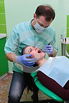 People, medicine, stomatology and health care concept - close up of dentists and assistant with mirror