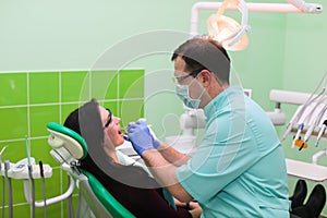 People, medicine, stomatology and health care concept - close up of dentists and assistant with mirror