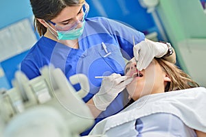 People, medicine, stomatology and health care concept - happy female dentist checking patient girl teeth