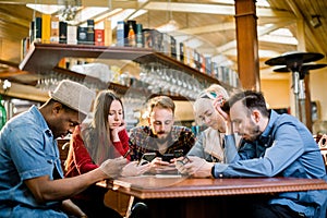 People Meeting Communication Technology Digital Tablet Concept. Group of five multiethnical students sitting in a cafe