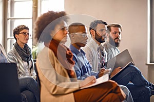 People on meeting listens lecturer