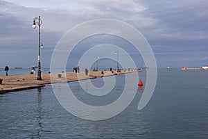 People on The Molo Audace pier of Trieste on a beautiful autumn day