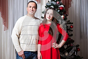 People, motherhood, family, christmas and adoption concept - happy father and daughter hugging at home
