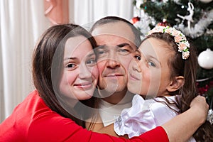 People, motherhood, family, christmas and adoption concept - happy father and daughter hugging at home