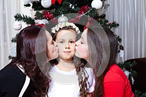 People, motherhood, family, christmas and adoption concept - happy mother and daughter hugging at home