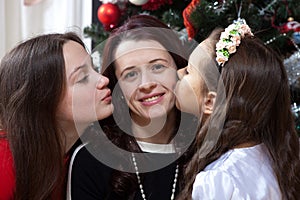 People, motherhood, family, christmas and adoption concept - happy mother and daughter hugging at home
