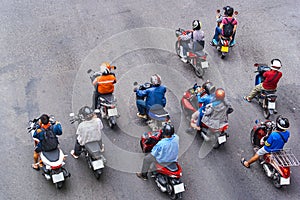 People are on motorbikes in huge Asian city
