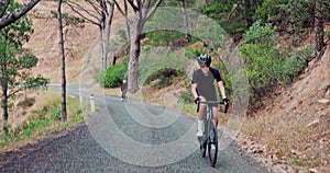 People, mountain and uphill adventure on bicycle for wellness exercise for triathlon training, endurance or workout. Man