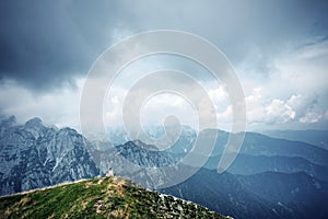 People in mountains, background alps