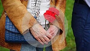 people and mourning concept - woman with white lily flowers and coffin at funeral in church