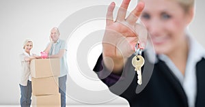 people moving boxes into new home with key