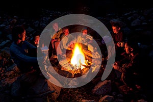 People near campfire in forest. photo