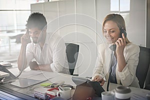 People in operations center talking on Landline phone.