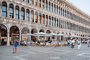 People at the outdoor tables of Ristorante Quadri on San Marco square in Venice, Italy