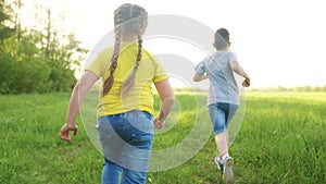 people in park. happy family children a kid together run in park at sunset silhouette. brother and sister run. happy