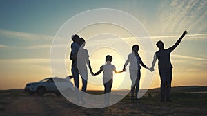 people in the park. happy family a silhouette walk at sunset. car travel kid dream concept. happy family parents and