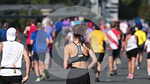 People participate run tournament. Marathoners jog distance. Girl athlete runner