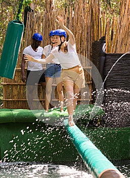 People passing crossbar with obstacles