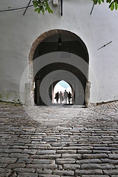 People passing through old city gate in Motovun, Croatia
