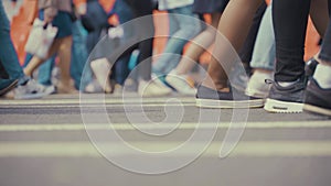 People pedestrians walks across a busy city street