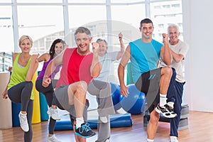 People performing aerobics exercise in gym class