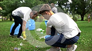 People picking up rubbish in plastic bag, waste treatment problem, recycling