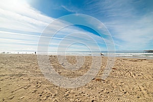 People in Pismo Beach shore on a cloudy day