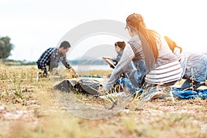 People Pitch a tent on the ground near the lake. Relaxing, traveling, long weeked, holiday concept