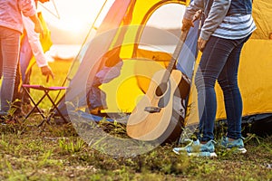 People Pitch a tent on the ground near the lake. Relaxing, traveling, long weeked, holiday concept