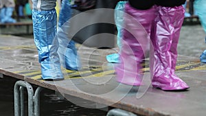People with plastic leggings during the flood in Venice