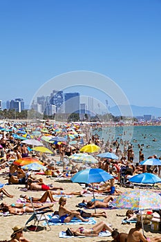 People at Platja del Bogatell beach, in Barcelona, Spain