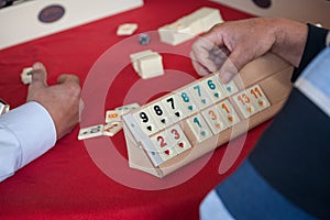 People play popular logic table game rummikub