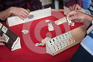 People play popular logic table game rummikub