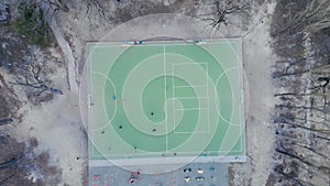 People play soccer. Football game on field, top down view. Football match play, drone shot. Aerial view of two teams playing ball