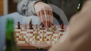 People playing chess board games on wooden table at home
