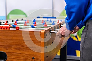 People playing foosball table soccer. Team sport, table football players. Competitive table game