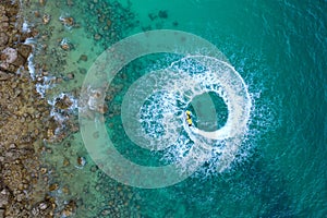 People are playing a jet ski in the sea.Aerial view. Top view. Amazing nature background. The color of the water and beautifully