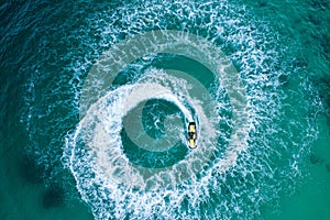 People are playing a jet ski in the sea.Aerial view. Top view.amazing nature background. The color of the water and beautifully