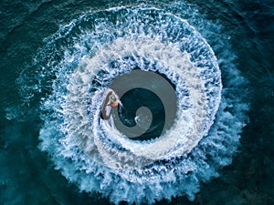 People are playing a jet ski in the sea.Aerial view. Top view.amazing nature background.The color of the water and beautifully br