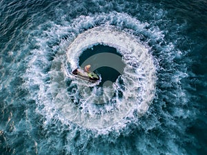 People are playing a jet ski in the sea.Aerial view. Top view.amazing nature background.The color of the water and beautifully br