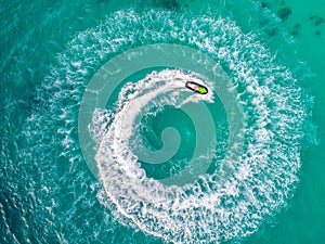 People are playing a jet ski in the sea.Aerial view. Top view.amazing nature background.The color of the water and beautifully br