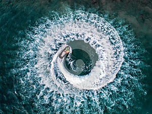 People are playing a jet ski in the sea.Aerial view. Top view.amazing nature background.The color of the water and beautifully br